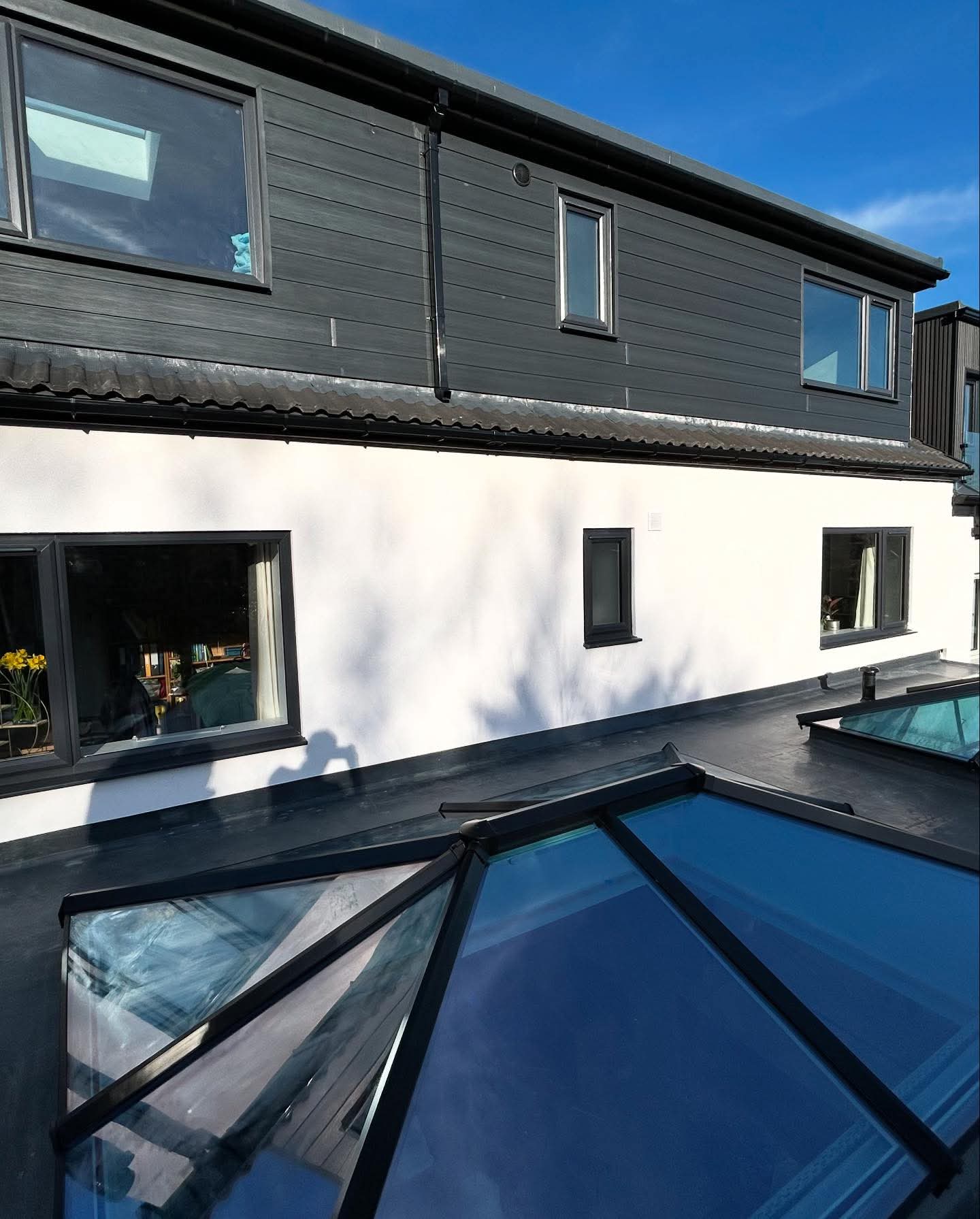 White render paired with dark cladding on a modernised Yorkshire home